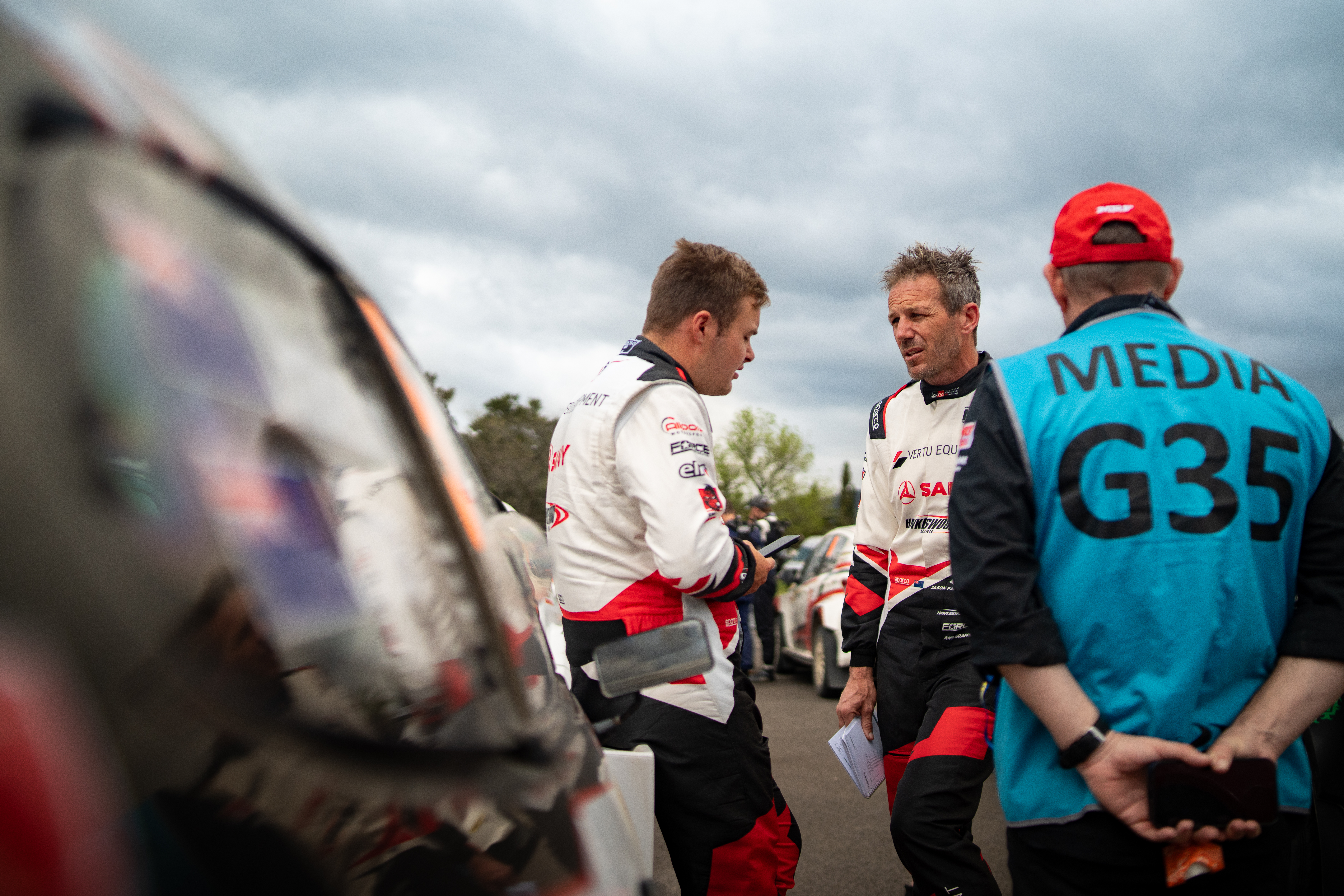 Race drivers in pit lane — event photography